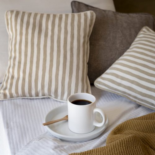 high-angle-cozy-bed-arrangement-with-coffee-cup