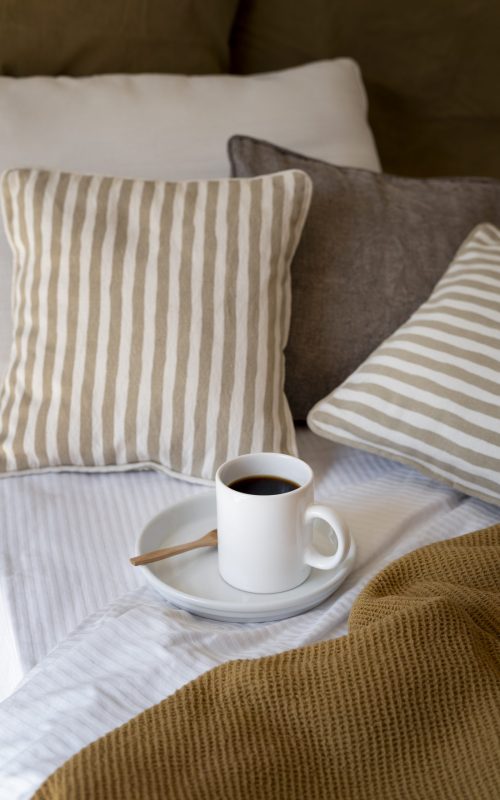 high-angle-cozy-bed-arrangement-with-coffee-cup